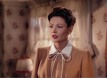 Movie still from “Leave Her to Heaven” (1945), directed by John M. Stahl – A woman in a brown suit with a white collar and tie; Close Up shot, Low angle