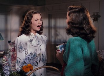 Movie still from “Leave Her to Heaven” (1945), directed by John M. Stahl – Two women talking to each other while holding a cup; Medium shot, Over the shoulder angle