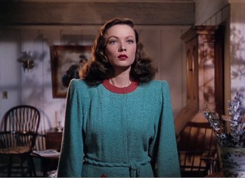 Movie still from “Leave Her to Heaven” (1945), directed by John M. Stahl – A woman standing in front of a table with a painting; Medium shot, Low angle