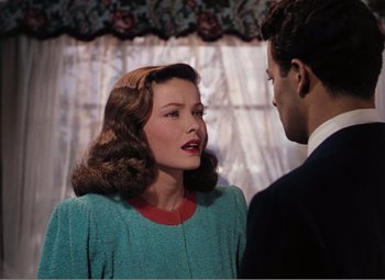 Movie still from “Leave Her to Heaven” (1945), directed by John M. Stahl – A man and a woman standing next to each other in front of a window; Medium shot, Over the shoulder angle