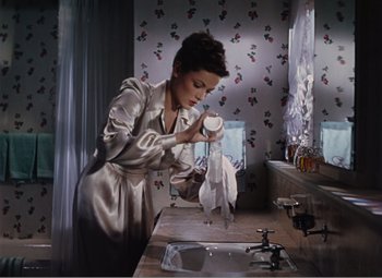 Movie still from “Leave Her to Heaven” (1945), directed by John M. Stahl – A woman in a satin robe is looking in the mirror; Medium shot, High angle