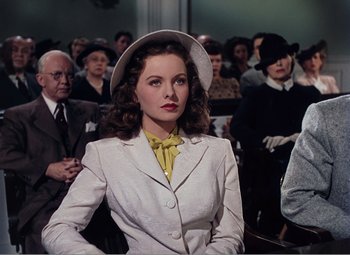 Movie still from “Leave Her to Heaven” (1945), directed by John M. Stahl – A woman wearing a white suit and a yellow tie; Medium shot, Over the shoulder angle