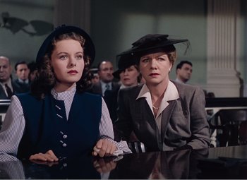Movie still from “Leave Her to Heaven” (1945), directed by John M. Stahl – Two women sitting at a table in front of other people; Medium shot, Low angle