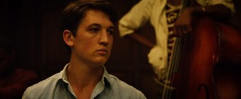 Movie still from “Whiplash” (2014), directed by Damien Chazelle – A young man is looking into the distance; Close Up shot, Over the shoulder angle