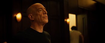 Movie still from “Whiplash” (2014), directed by Damien Chazelle – A bald man looking up into the sky; Close Up shot, Low angle