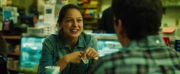 Movie still from “Whiplash” (2014), directed by Damien Chazelle – A woman sitting in front of a man at a table; Close Up shot, Over the shoulder angle