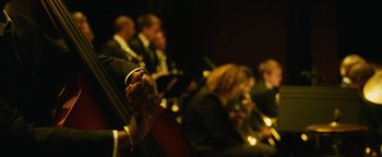 Movie still from “Whiplash” (2014), directed by Damien Chazelle – The hands of a person holding a cello; Extreme Close Up shot, Low angle