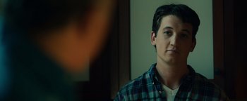 Movie still from “Whiplash” (2014), directed by Damien Chazelle – A man in a plaid shirt is looking at the camera; Close Up shot, Over the shoulder angle