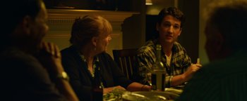 Movie still from “Whiplash” (2014), directed by Damien Chazelle – Two people sitting at a dinner table talking to each other; Medium shot, Over the shoulder angle