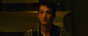 Movie still from “Whiplash” (2014), directed by Damien Chazelle – A man in a plaid shirt is looking at the camera; Close Up shot, Over the shoulder angle