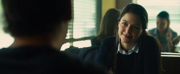 Movie still from “Whiplash” (2014), directed by Damien Chazelle – A woman sitting in front of a man in front of a window; Close Up shot, Over the shoulder angle