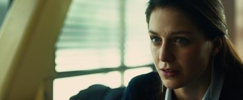 Movie still from “Whiplash” (2014), directed by Damien Chazelle – A woman's face in front of a window; Close Up shot, Over the shoulder angle