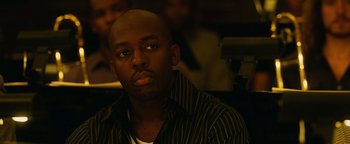 Movie still from “Whiplash” (2014), directed by Damien Chazelle – A person sitting in front of a camera; Close Up shot, High angle