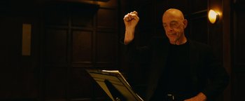 Movie still from “Whiplash” (2014), directed by Damien Chazelle – A man sitting in front of a sheet of paper; Close Up shot, Low angle