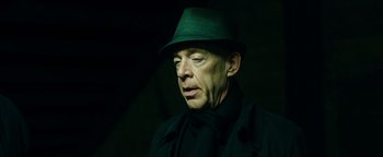 Movie still from “Whiplash” (2014), directed by Damien Chazelle – A person wearing a green hat; Close Up shot, Low angle