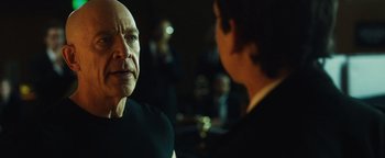 Movie still from “Whiplash” (2014), directed by Damien Chazelle – A man in a black shirt is talking to another man in a black suit; Close Up shot, Over the shoulder angle