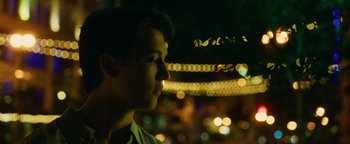 Movie still from “Whiplash” (2014), directed by Damien Chazelle – A young man looking into the distance in the dark; Close Up shot, Low angle