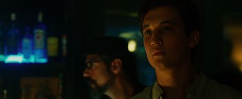 Movie still from “Whiplash” (2014), directed by Damien Chazelle – A man and a man with glasses in a dark room; Close Up shot, Low angle