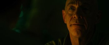 Movie still from “Whiplash” (2014), directed by Damien Chazelle – A person's face in a dark room; Close Up shot, Low angle