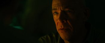 Movie still from “Whiplash” (2014), directed by Damien Chazelle – A person's face in the dark; Close Up shot, Low angle