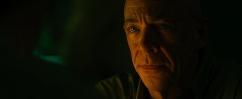 Movie still from “Whiplash” (2014), directed by Damien Chazelle – A person's face in the dark; Close Up shot, Over the shoulder angle