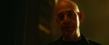 Movie still from “Whiplash” (2014), directed by Damien Chazelle – An older man with a bald head is looking at the camera; Close Up shot, Low angle