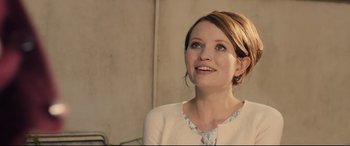 Movie still from “Legend” (2015), directed by Brian Helgeland – A woman is smiling while looking up at the sky; Close Up shot, Over the shoulder angle