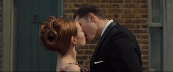 Movie still from “Legend” (2015), directed by Brian Helgeland – A man and a woman kissing in front of a brick wall; Close Up shot, Over the shoulder angle
