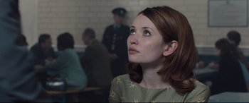 Movie still from “Legend” (2015), directed by Brian Helgeland – A woman in a green dress looking up to the sky; Close Up shot, Low angle