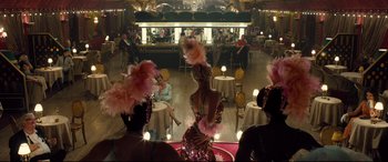 Movie still from “Legend” (2015), directed by Brian Helgeland – A woman in a pink dress in the middle of a dance floor; Wide shot, High angle