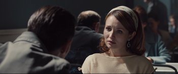 Movie still from “Legend” (2015), directed by Brian Helgeland – A woman in a white shirt is talking to a man; Close Up shot, Over the shoulder angle