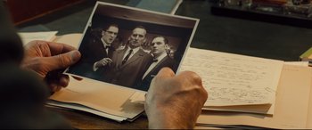 Movie still from “Legend” (2015), directed by Brian Helgeland – An old photo of three men in business suits; Extreme Close Up shot, Over the shoulder angle
