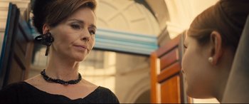 Movie still from “Legend” (2015), directed by Brian Helgeland – A person wearing a necklace; Close Up shot, Low angle