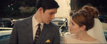 Movie still from “Legend” (2015), directed by Brian Helgeland – A man and a woman standing next to each other on the street; Close Up shot, Over the shoulder angle