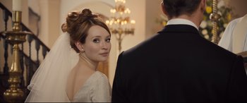 Movie still from “Legend” (2015), directed by Brian Helgeland – A beautiful young woman wearing a white dress; Close Up shot, Over the shoulder angle