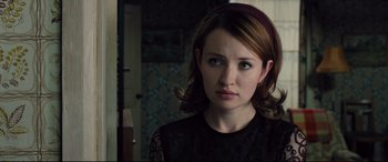 Movie still from “Legend” (2015), directed by Brian Helgeland – A young woman with red hair wearing a black top; Close Up shot, Over the shoulder angle