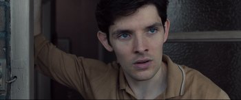 Movie still from “Legend” (2015), directed by Brian Helgeland – A man's face with blue eyes; Close Up shot, High angle