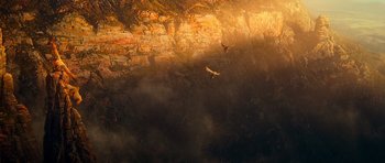 Movie still from “Legend of the Guardians: The Owls of Ga'Hoole” (2010), directed by Zack Snyder – Two birds flying over a rocky cliff at sunset; Extreme Wide shot, Low angle