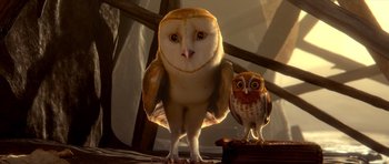 Movie still from “Legend of the Guardians: The Owls of Ga'Hoole” (2010), directed by Zack Snyder – An owl standing next to an owl sitting on top of a book; Medium shot, Low angle
