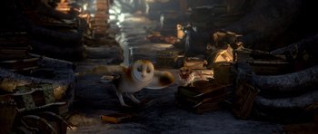 Movie still from “Legend of the Guardians: The Owls of Ga'Hoole” (2010), directed by Zack Snyder – An owl and an owl standing next to a pile of books; Wide shot, High angle