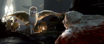 Movie still from “Legend of the Guardians: The Owls of Ga'Hoole” (2010), directed by Zack Snyder – An owl is standing on the ground next to a man; Medium shot, Over the shoulder angle