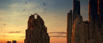 Movie still from “Legend of the Guardians: The Owls of Ga'Hoole” (2010), directed by Zack Snyder – Birds flying over a rock formation at sunset; Extreme Wide shot, Low angle