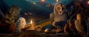 Movie still from “Legend of the Guardians: The Owls of Ga'Hoole” (2010), directed by Zack Snyder – An owl sitting on top of a table next to a fire; Wide shot, Low angle