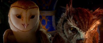 Movie still from “Legend of the Guardians: The Owls of Ga'Hoole” (2010), directed by Zack Snyder – An owl and a bird are sitting next to each other; Close Up shot, Low angle