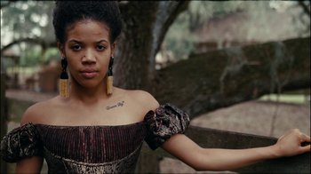 Movie still from “Lemonade” (2016), directed by Mark Romanek – A young woman in a dress is standing by a tree; Close Up shot, Low angle
