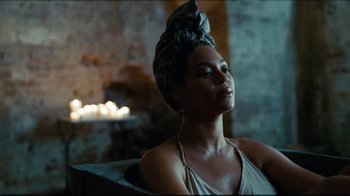 Movie still from “Lemonade” (2016), directed by Mark Romanek – A woman sitting in a chair with her eyes closed; Medium shot, Over the shoulder angle