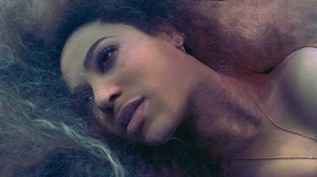 Movie still from “Lemonade” (2016), directed by Mark Romanek – A person laying on the ground; Close Up shot, Overhead angle