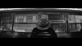 Movie still from “Lemonade” (2016), directed by Mark Romanek – A man sitting in a chair wearing a hat; Close Up shot, High angle