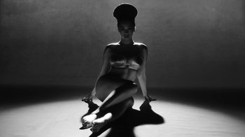 Movie still from “Lemonade” (2016), directed by Mark Romanek – A black and white photo of a woman sitting on the ground; Wide shot, Overhead angle