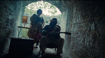 Movie still from “Lemonade” (2016), directed by Mark Romanek – A man and a woman are playing a guitar; Wide shot, Low angle